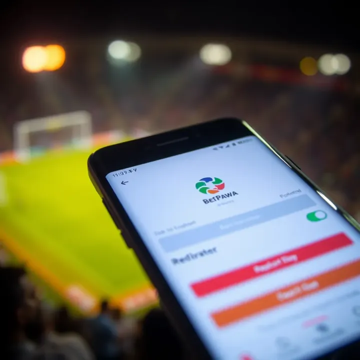 Android phone displaying BetPawa app registration screen with bright interface